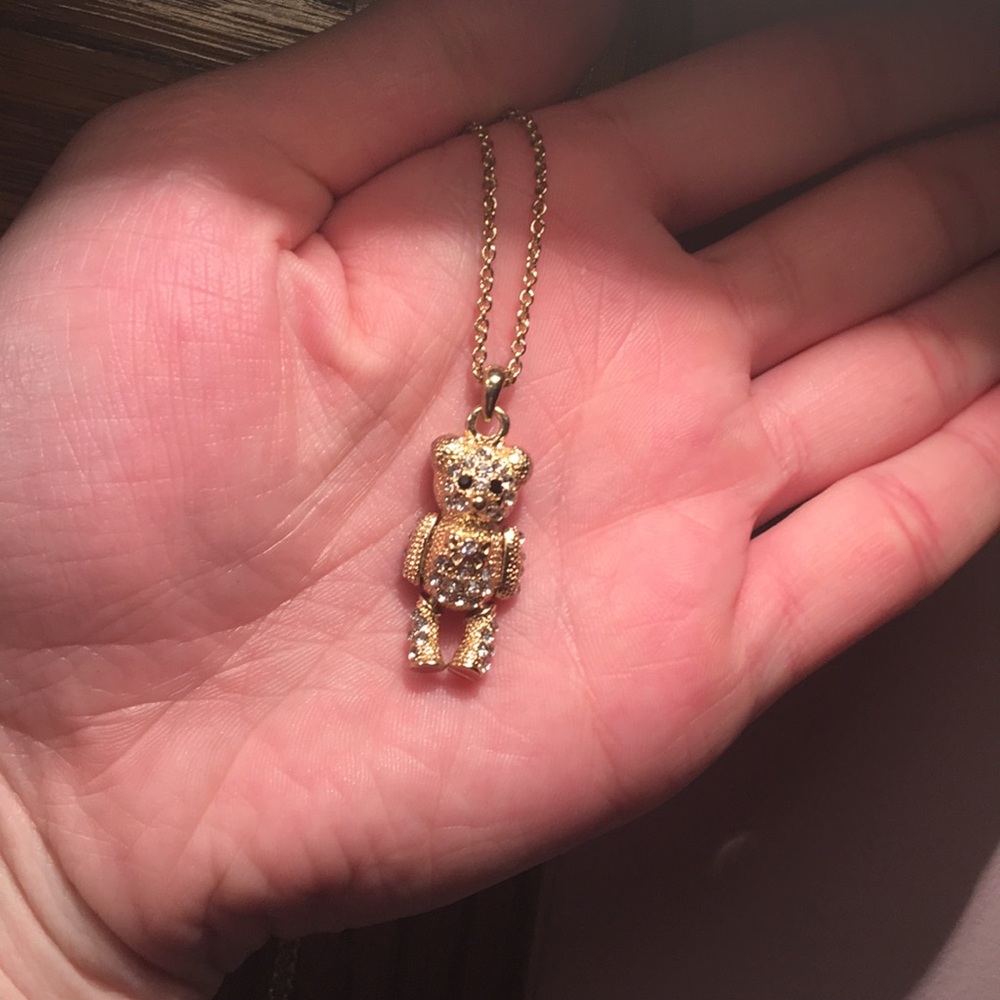 Gold teddy bear necklace.